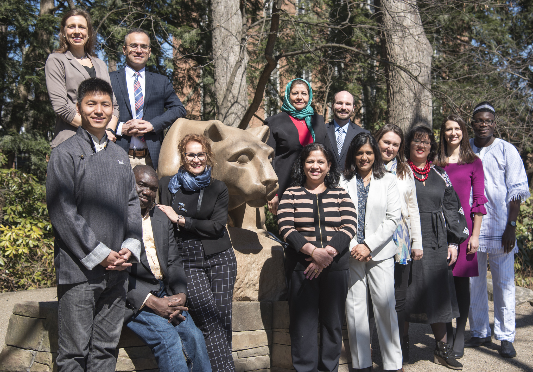 Group of students standing in front of the lion shrine