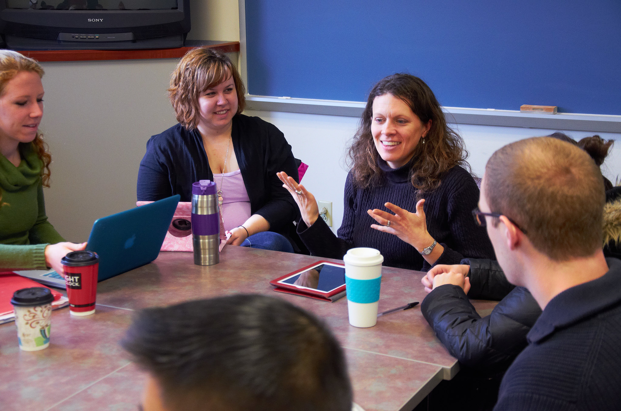 group of individuals engaging in conversation around a table