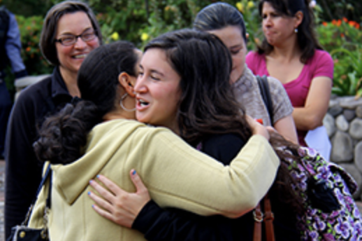 Two students hugging each other 