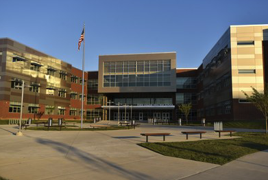 Picture of the front entrance of the state college high school building. 