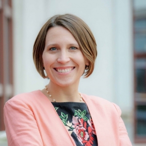 woman in peach blazer with short hair